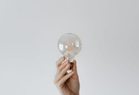 Smart Lighting - Anonymous female showing light bulb