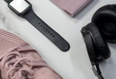 Fitness Trackers - Black and Silver Headphones Beside Red and Black Headphones