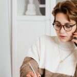 Smart Glasses - Modern businesswoman in casual outfit talking on mobile in office