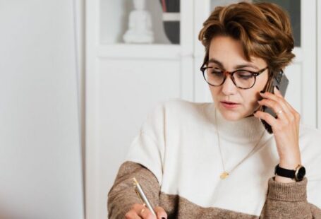 Smart Glasses - Modern businesswoman in casual outfit talking on mobile in office