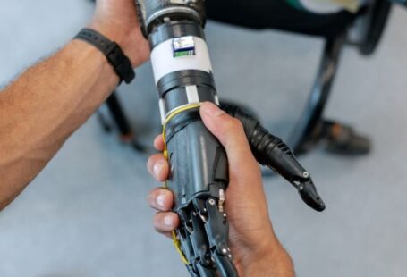 Robotic Exoskeletons - Person Holding Prosthetic Arm