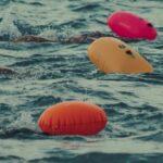 Security Features - Swimmers in the ocean with floating balls