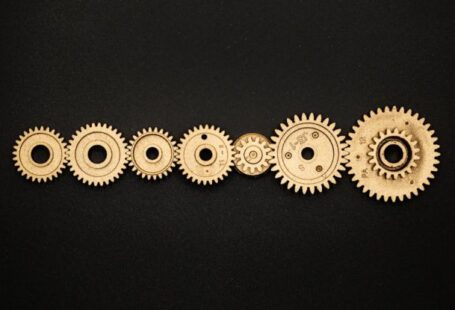 Progress - Photo of Golden Cogwheel on Black Background