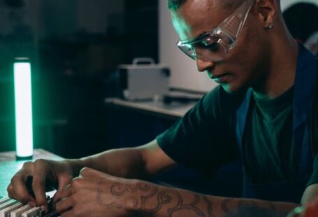 Software Innovations - A Man in Black Shirt Wearing Safety Glasses