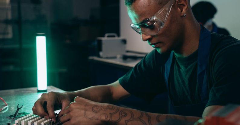 Software Innovations - A Man in Black Shirt Wearing Safety Glasses