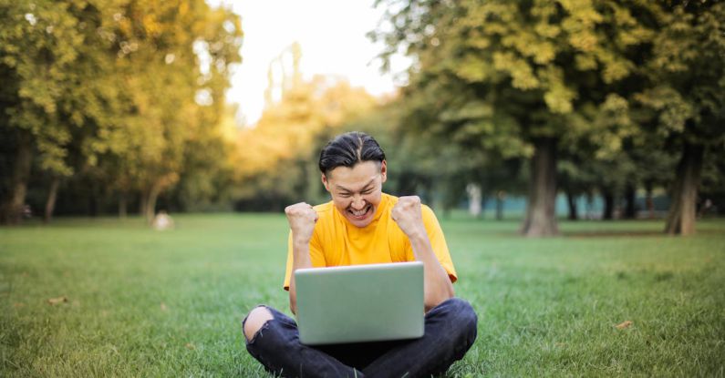 Approaches - Man Sitting on a Green Grass Field