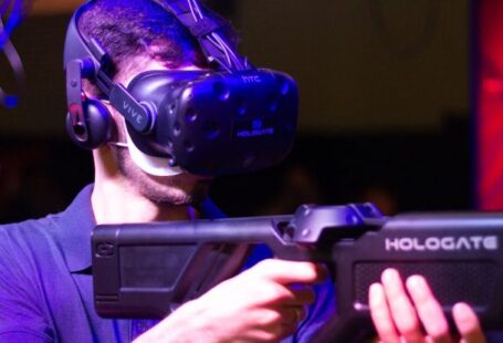 Virtual Reality Software - Man in VR with game riffle playing video game