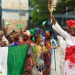 Decentralized Identity - A group of people holding flags and dancing