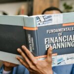 Fundamentals - Person Reading a Book About Fundamentals of Financial Planning