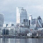 Central Banks - Contemporary multistory high rise business centers located on embankment with trees near Thames river in London city