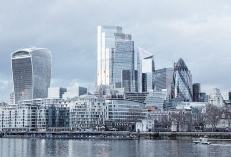 Central Banks - Contemporary multistory high rise business centers located on embankment with trees near Thames river in London city