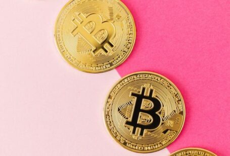 Blockchain Technology - Gold Round Coins on Pink Surface