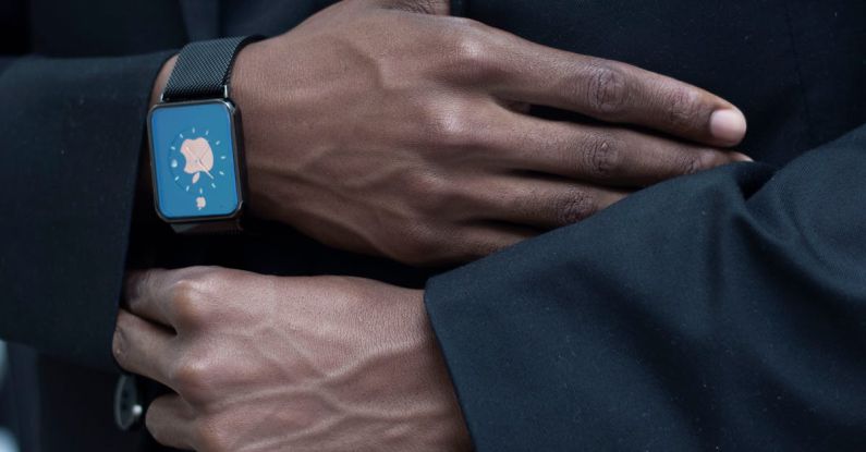 Wearable Devices - Anonymous person adjusting suit of unrecognizable African American gentleman in elegant outfit with modern smart watch